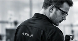An engineer looking closely at a piece of equipment